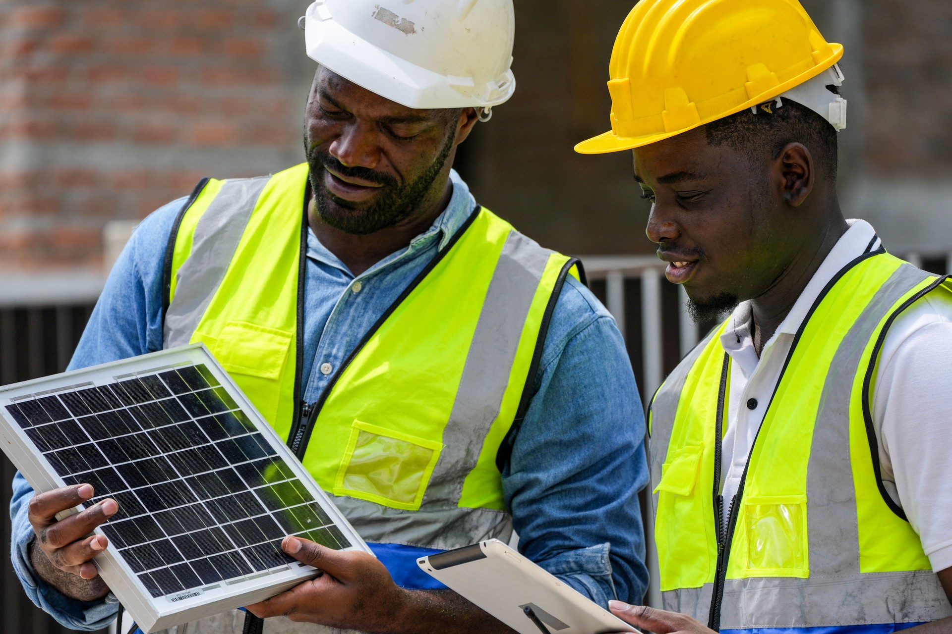 Two professional Black engineers collaborating on a building project. A skilled architect discusses plans with his colleague, representing diversity and expertise in the construction industry.